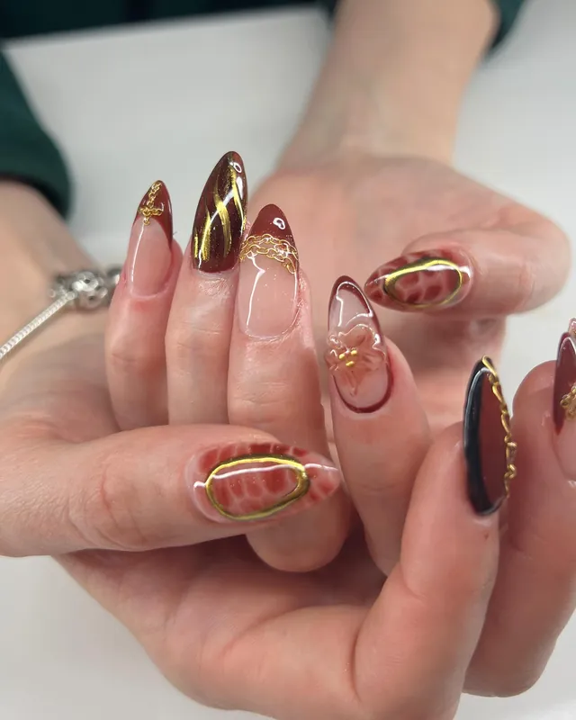 Almond Gel-X nails in brown and gold fall designs