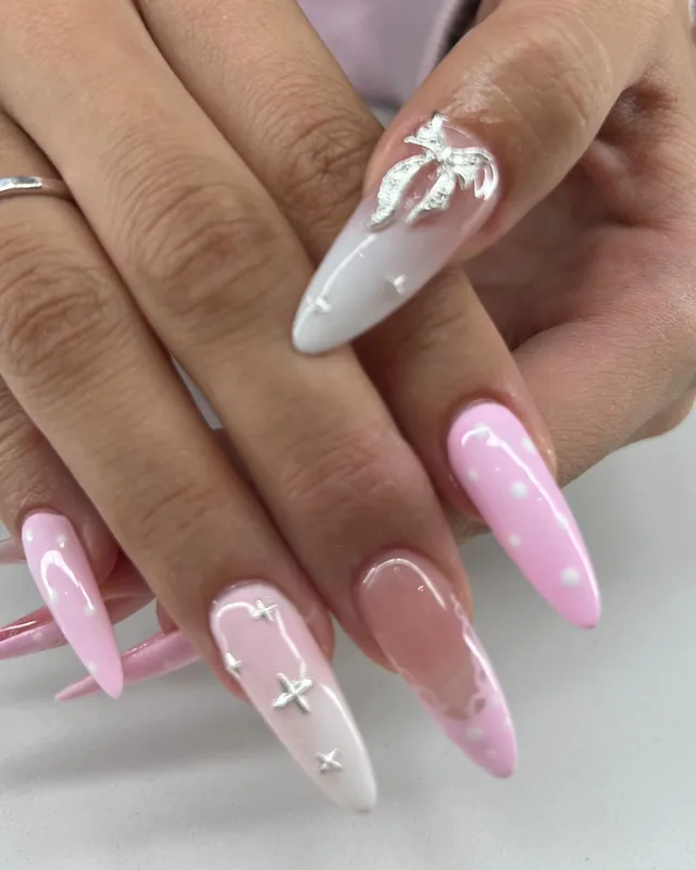 Long pink almond Gel-X nails with white and silver accents